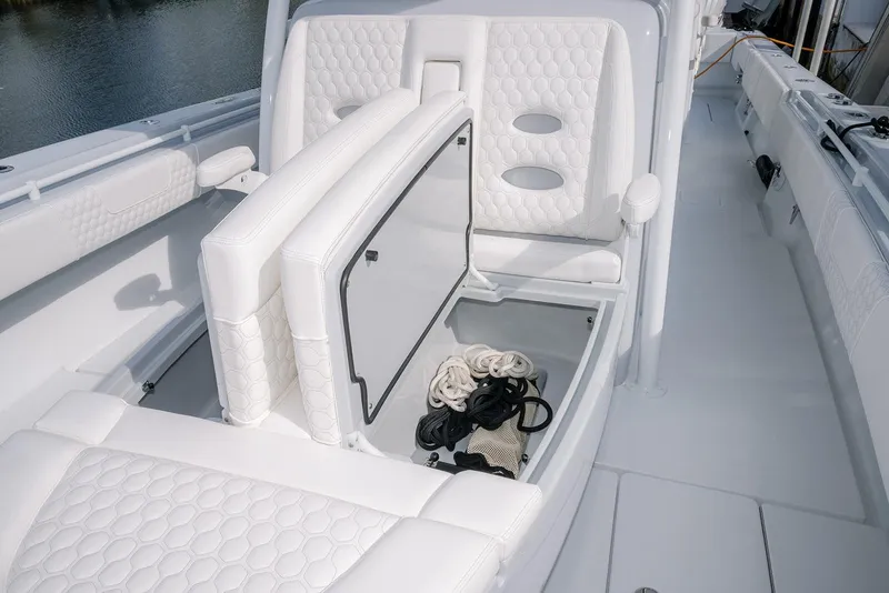Slide: The Image of 2024 Contender 44 ST boat interior with white seating and storage compartment. - 56