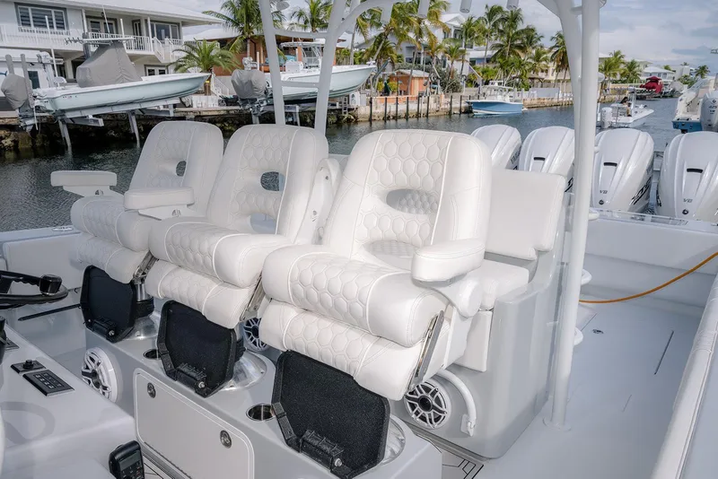 Slide: The Image of 2024 Contender 44 ST boat interior with luxurious white seating and multiple outboard engines. - 58