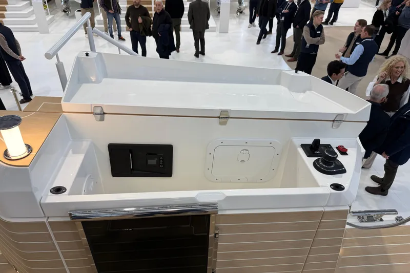 Slide: The Image of 2026 Saxdor 460 GTC boat interior at a crowded exhibition, showcasing modern design features. - 7