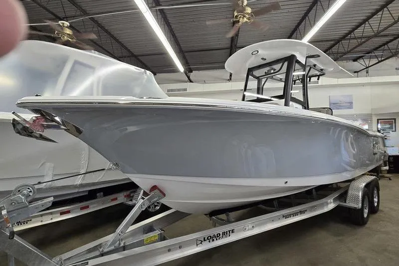 The Image of 2026 Sea Hunt Ultra 265 SE boat on trailer in showroom. - 0