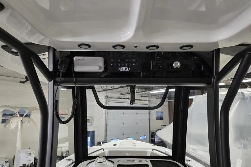 Slide: The Image of 2026 Sea Hunt Ultra 265 SE boat console with electronics and controls in a showroom. - 10