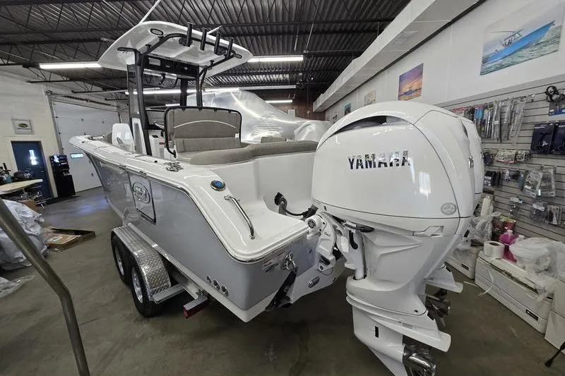 Slide: The Image of 2026 Sea Hunt Ultra 265 SE boat with Yamaha engine in showroom. - 13