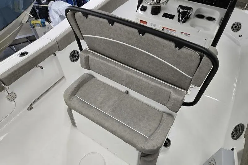 Slide: The Image of 2026 Sea Hunt Ultra 265 SE boat interior with cushioned seating and control panel. - 2