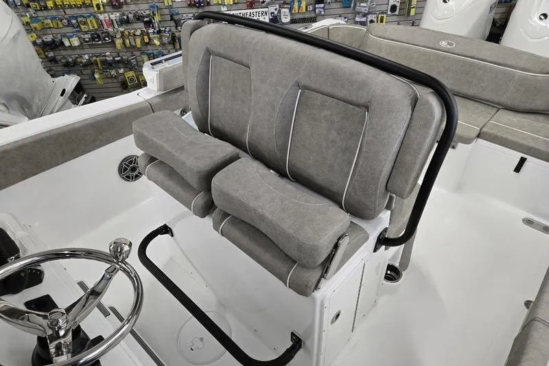 Slide: The Image of 2026 Sea Hunt Ultra 265 SE boat interior with cushioned seating and steering wheel. - 5