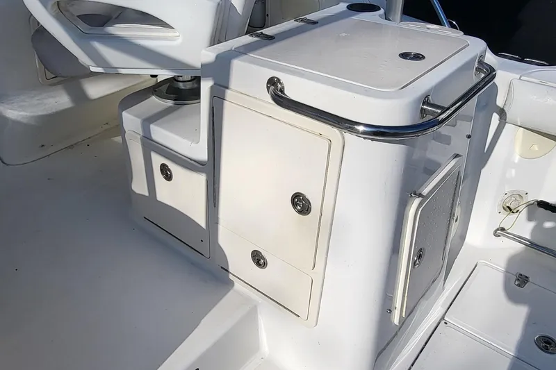 Slide: The Image of 2008 Boston Whaler 305 Conquest boat interior with storage compartments and seating. - 10