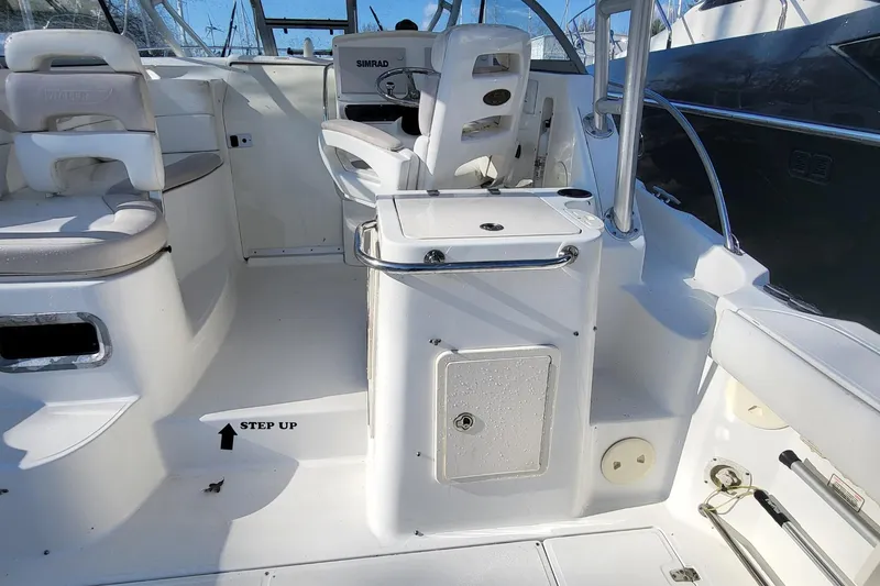 Slide: The Image of 2008 Boston Whaler 305 Conquest boat interior with helm and seating area. - 11