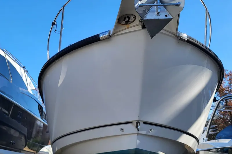 Slide: The Image of 2008 Boston Whaler 305 Conquest boat bow under clear blue sky. - 13