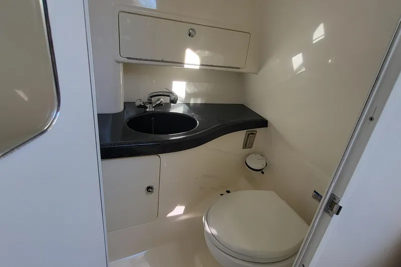 Slide: The Image of 2008 Boston Whaler 305 Conquest boat bathroom with sink and toilet. - 17