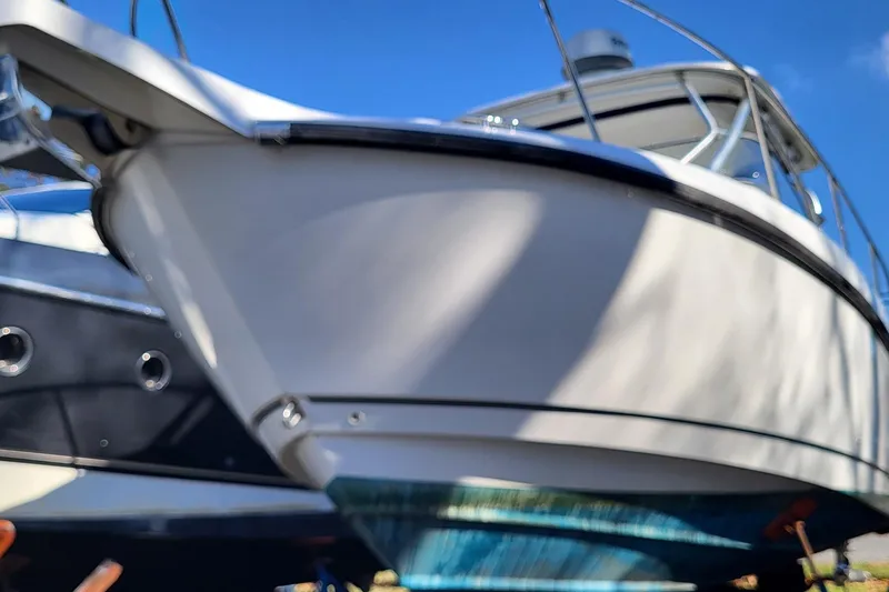 Slide: The Image of 2008 Boston Whaler 305 Conquest boat with blue sky background. - 2