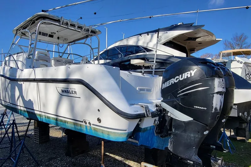 Slide: The Image of 2008 Boston Whaler 305 Conquest boat with Mercury outboard engines on display. - 3