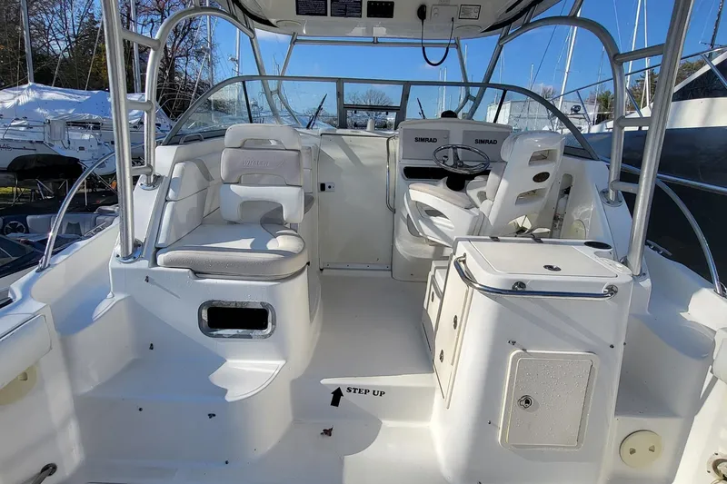 Slide: The Image of 2008 Boston Whaler 305 Conquest boat interior with helm, seating, and navigation equipment. - 5