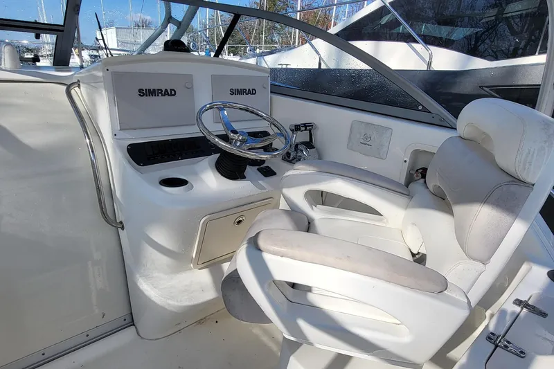 Slide: The Image of 2008 Boston Whaler 305 Conquest helm with Simrad electronics and comfortable seating. - 6