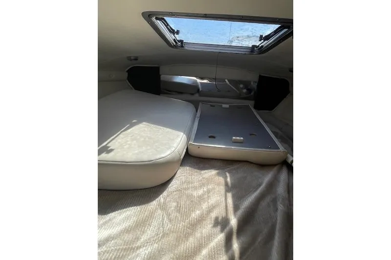 Slide: The Image of 1998 Chaparral 2835 SS boat interior cabin with cushioned seating and overhead hatch. - 12