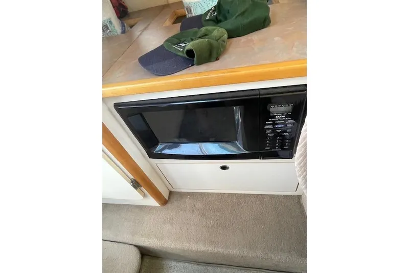 Slide: The Image of 1998 Chaparral 2835 SS boat interior with microwave and countertop accessories. - 14