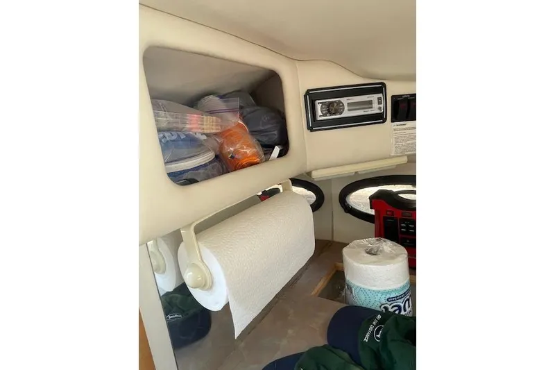 Slide: The Image of Interior of 1998 Chaparral 2835 SS boat with storage and radio system. - 16