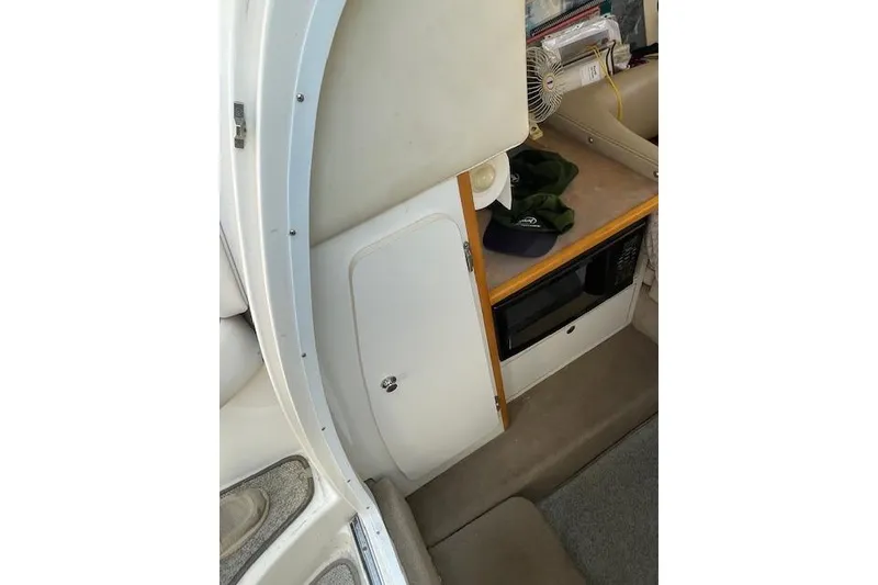Slide: The Image of Interior of 1998 Chaparral 2835 SS boat with microwave and storage. - 19
