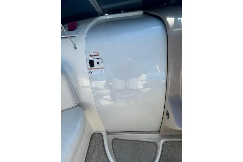Slide: The Image of 1998 Chaparral 2835 SS boat interior with seating and cabin door. - 21