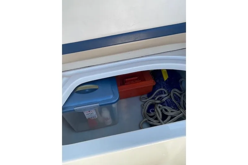 Slide: The Image of Storage compartment in a 1998 Chaparral 2835 SS boat with rope and containers. - 22