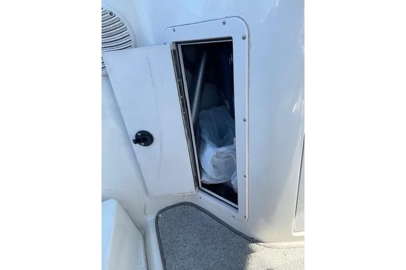 Slide: The Image of Open storage compartment on 1998 Chaparral 2835 SS boat, showing interior space. - 25