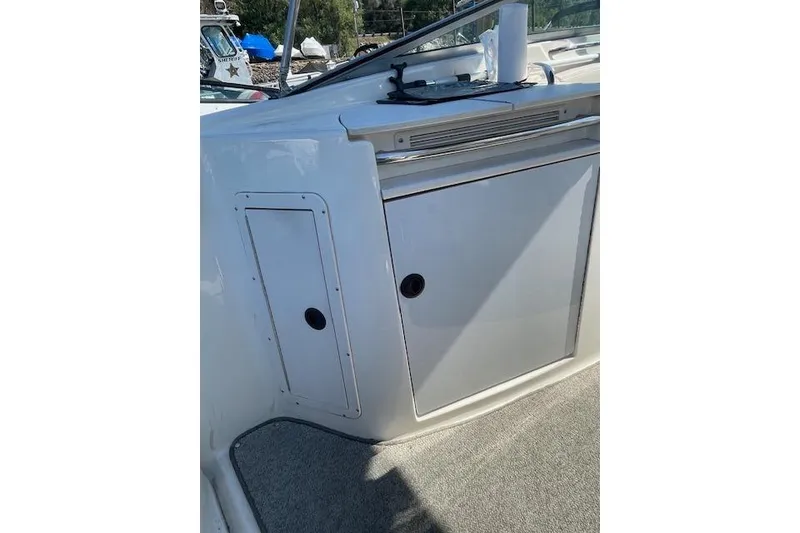 Slide: The Image of 1998 Chaparral 2835 SS boat interior with storage compartments and carpeted flooring. - 26