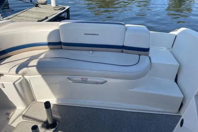 Slide: The Image of 1998 Chaparral 2835 SS boat interior with white and blue seating by the water. - 27