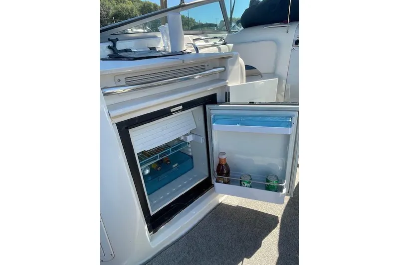 Slide: The Image of 1998 Chaparral 2835 SS boat with open mini fridge, stocked with drinks. - 29