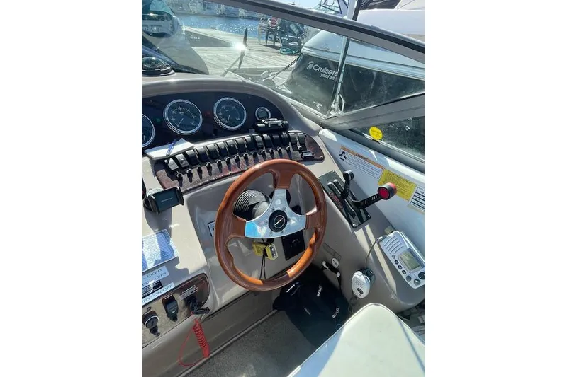 Slide: The Image of 1998 Chaparral 2835 SS boat dashboard with steering wheel and control panel. - 36
