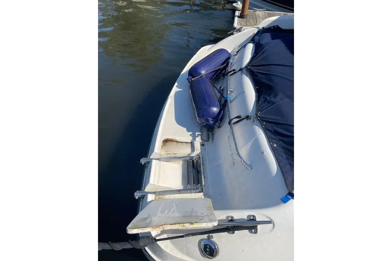 Slide: The Image of 1998 Chaparral 2835 SS boat with blue fenders docked on calm water. - 39
