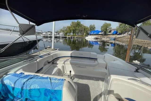 Slide: The Image of 1998 Chaparral 2835 SS boat interior with seating, docked at a marina. - 41