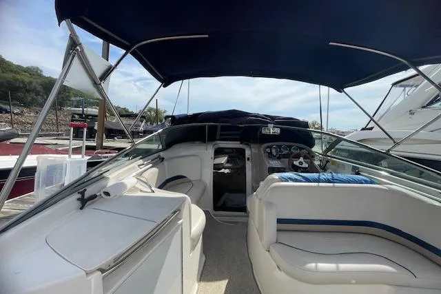 Slide: The Image of 1998 Chaparral 2835 SS boat interior with seating and canopy, docked at marina. - 42