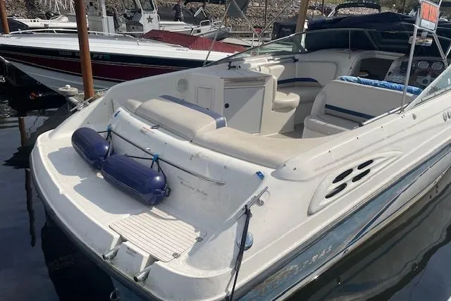 Slide: The Image of 1998 Chaparral 2835 SS boat docked, featuring spacious seating and sleek design. - 43