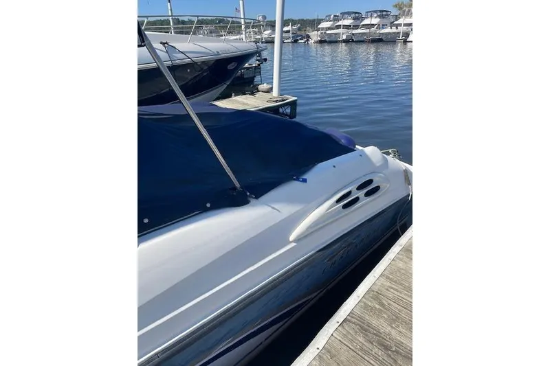 Slide: The Image of 1998 Chaparral 2835 SS boat docked at marina with blue cover. - 44