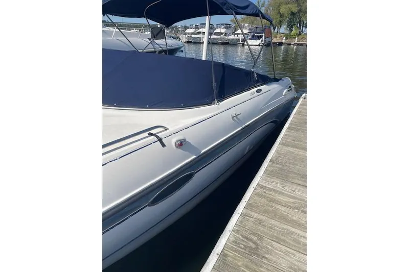 Slide: The Image of 1998 Chaparral 2835 SS boat docked with blue cover and canopy. - 45