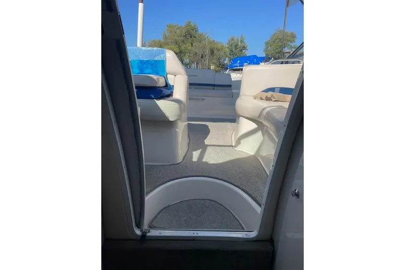 Slide: The Image of 1998 Chaparral 2835 SS boat interior with beige seating and blue accents. - 8