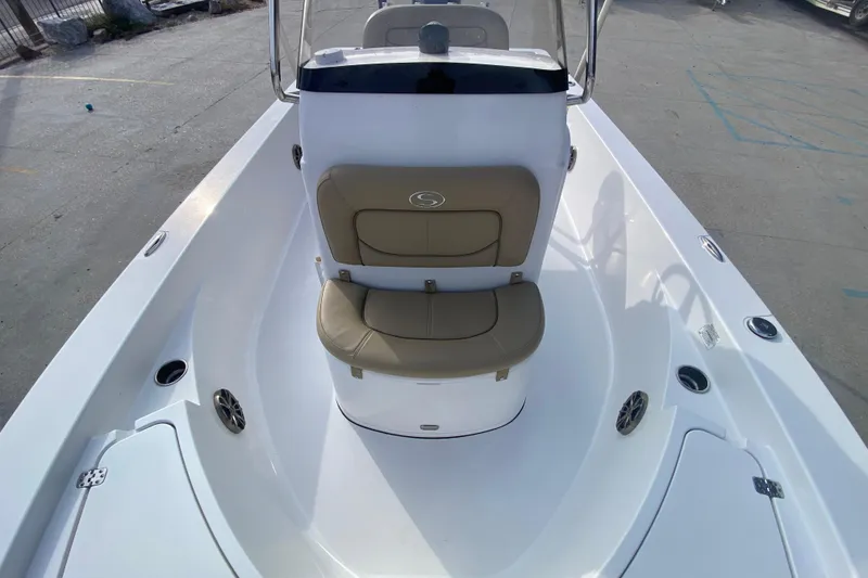 Slide: The Image of 2015 Sportsman Masters 227 Bay Boat interior with tan seating and console. - 12