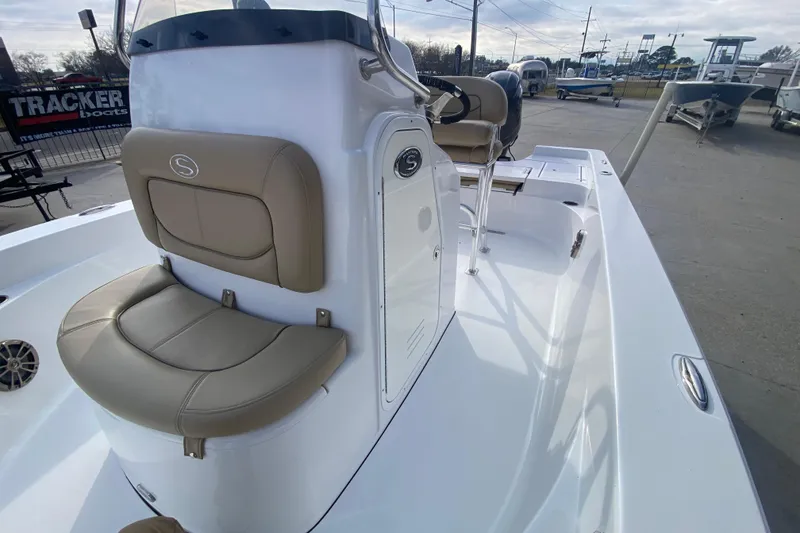 Slide: The Image of 2015 Sportsman Masters 227 Bay Boat with beige seating and sleek white deck. - 13