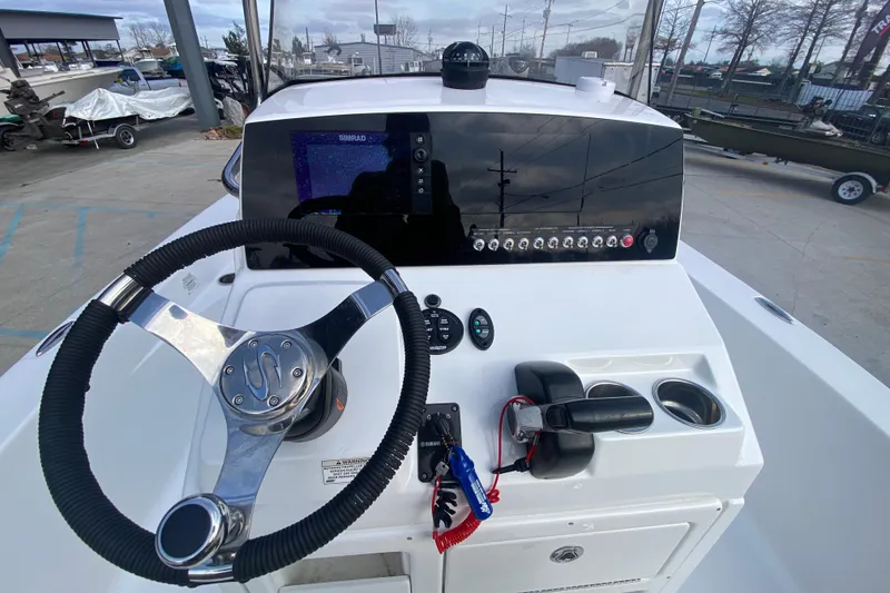 Slide: The Image of 2015 Sportsman Masters 227 Bay Boat dashboard with steering wheel and controls. - 19