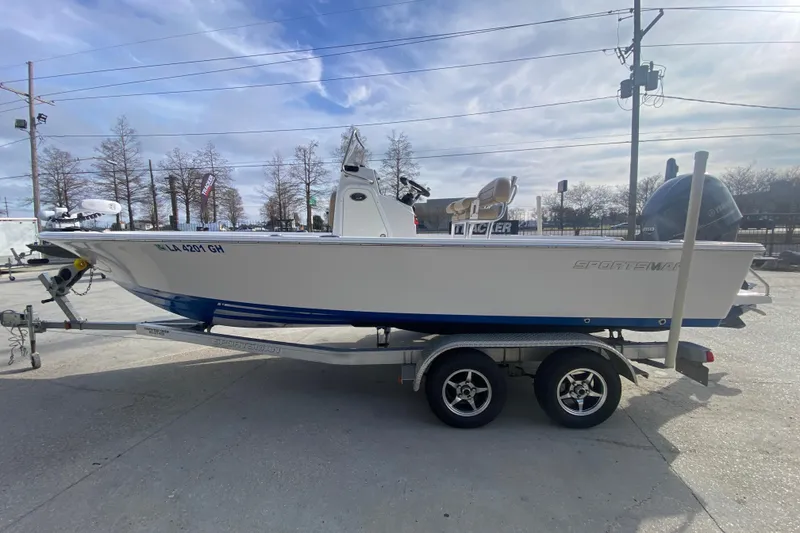 Slide: The Image of 2015 Sportsman Masters 227 Bay Boat on trailer, parked outdoors under a cloudy sky. - 5