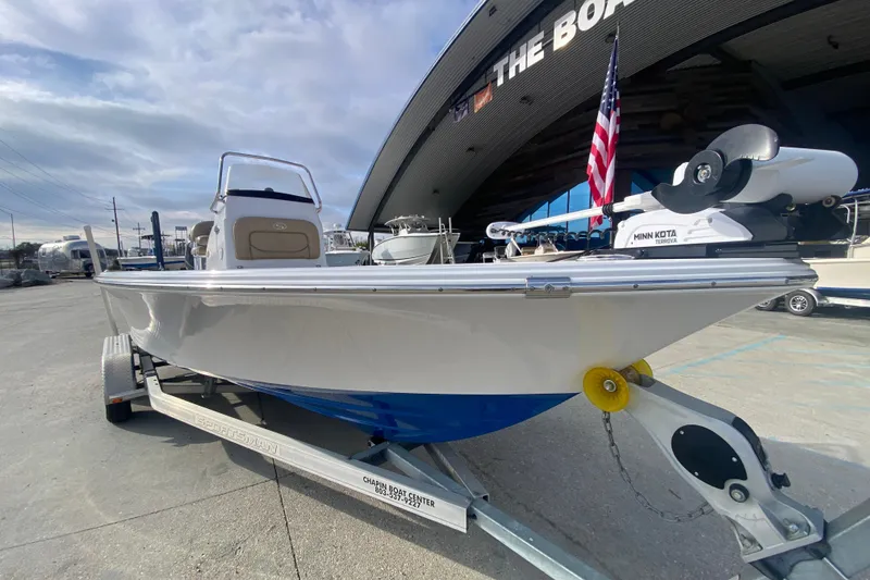 Slide: The Image of 2015 Sportsman Masters 227 Bay Boat on trailer, displayed outdoors with American flag. - 8