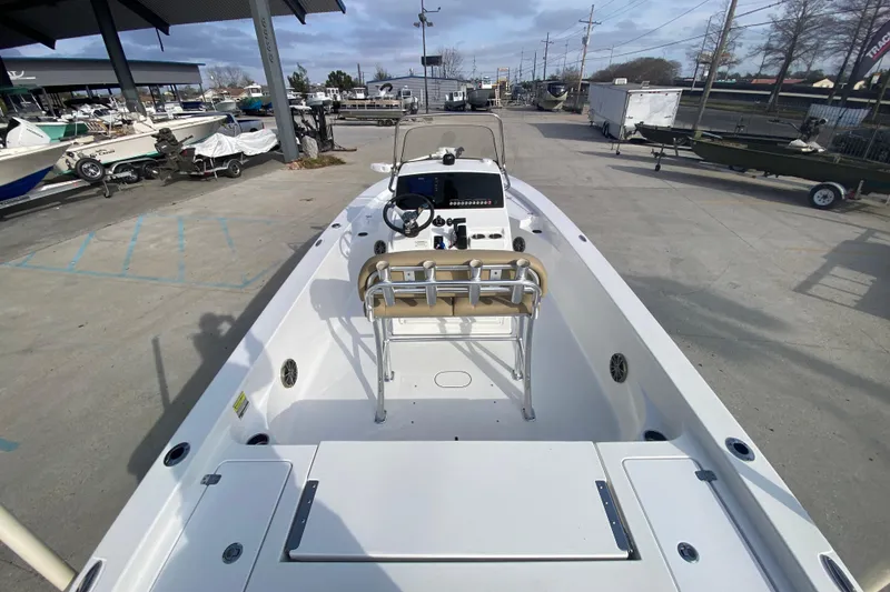 Slide: The Image of 2015 Sportsman Masters 227 Bay Boat in a marina, showcasing spacious deck and console. - 9