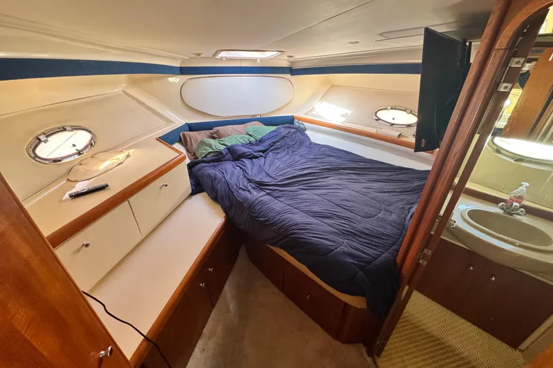 Slide: The Image of Cozy cabin interior of 1997 Carver 350 Mariner yacht with bed and portholes. - 13
