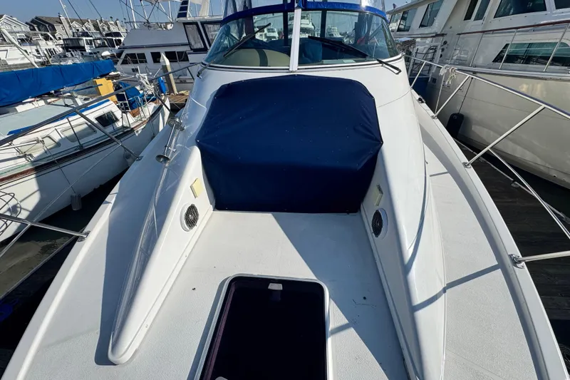 Slide: The Image of 1997 Carver 350 Mariner yacht docked at marina, featuring sleek white deck design. - 20