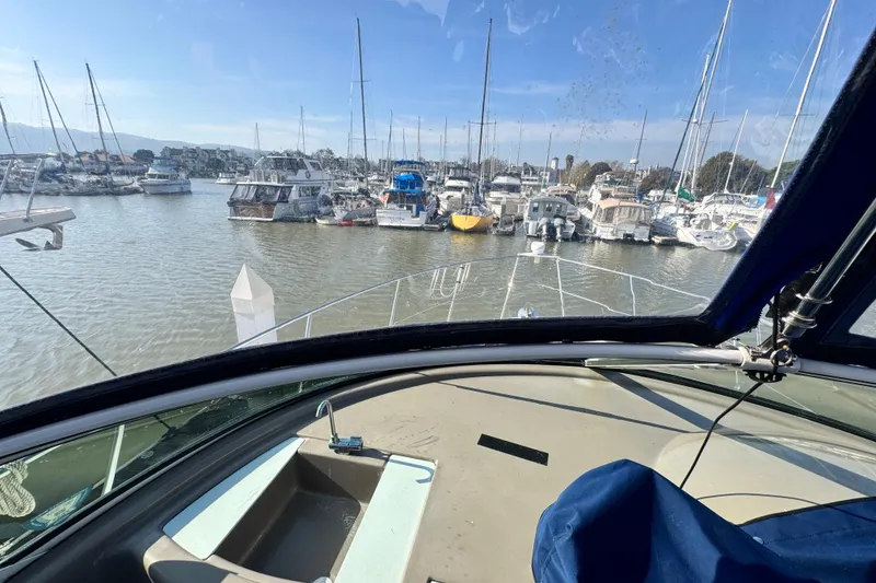 Slide: The Image of 1997 Carver 350 Mariner yacht docked in a busy marina, viewed from the helm. - 26