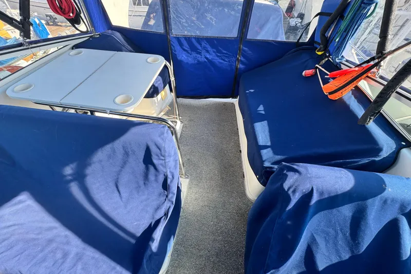 Slide: The Image of 1997 Carver 350 Mariner interior with blue covers and a foldable table. - 28