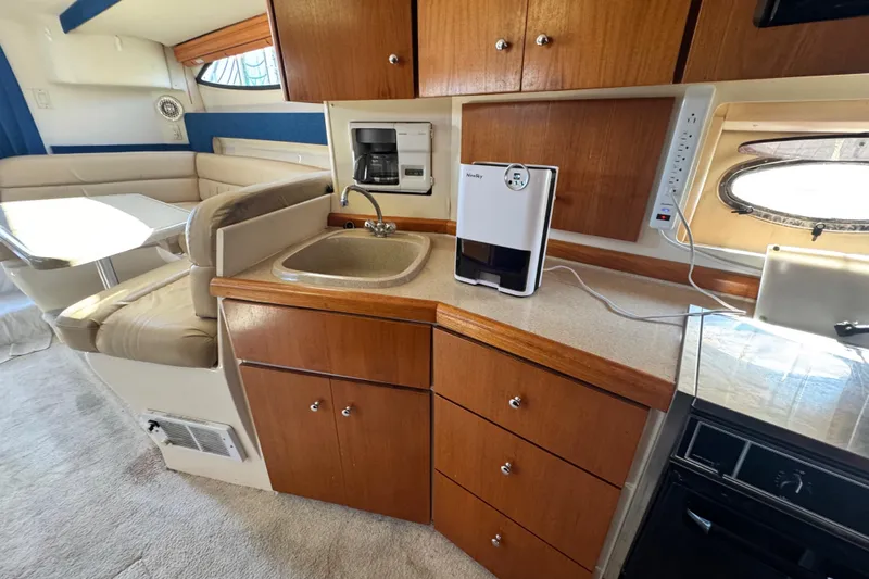 Slide: The Image of Interior of 1997 Carver 350 Mariner yacht with kitchenette and seating area. - 10