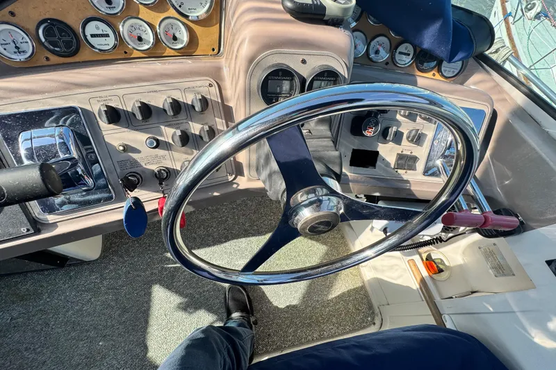 Slide: The Image of 1997 Carver 350 Mariner helm with steering wheel and control panel. - 29