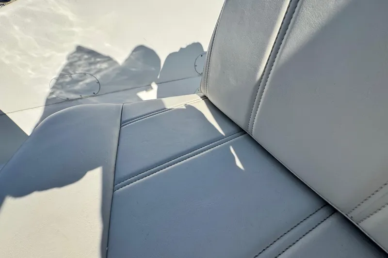 Slide: The Image of White leather seating on a 1997 Carver 350 Mariner boat, with visible stitching. - 32
