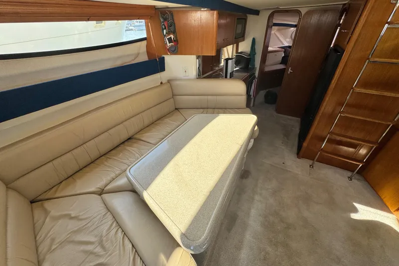 Slide: The Image of Interior of 1997 Carver 350 Mariner yacht with beige seating and dining area. - 8