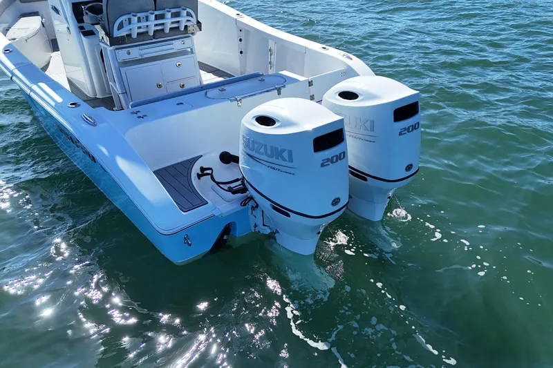 Slide: The Image of 2022 Sea Pro 259 Center Console boat with twin Suzuki 200 engines on water. - 10