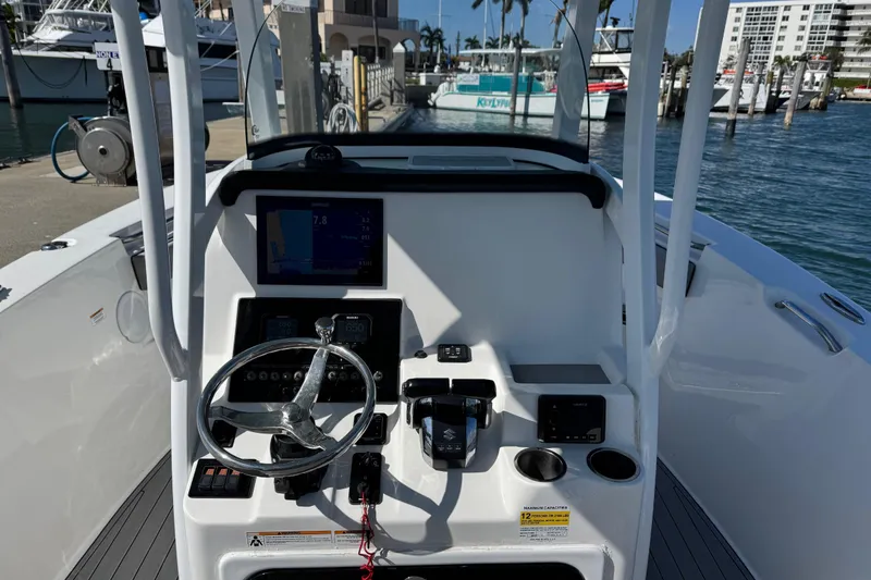 Slide: The Image of Helm of a 2022 Sea Pro 259 Center Console boat docked at marina. - 13